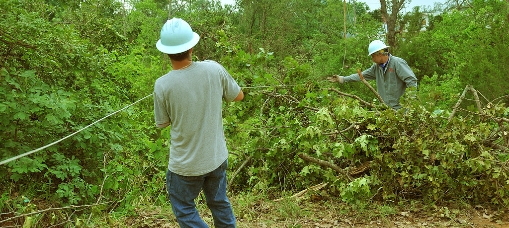 Electric utility workers restoring power